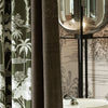 Close-up of LOOM blackout curtain fabric showing dual-layer construction with intricate jacquard texture and natural-themed lining for enhanced room ambiance.

