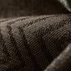 Extreme close-up of LOOM curtain textile highlighting thick weave, fine detailing, and premium blackout material texture in deep earth tones.