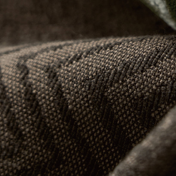 Extreme close-up of LOOM curtain textile highlighting thick weave, fine detailing, and premium blackout material texture in deep earth tones.
