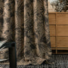 Close-up of NATURAL collection curtain fabric in earth taupe with charcoal botanical print, highlighting jacquard weave texture and high-end blackout lining.