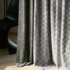 Close-up of NOVA curtain fabric, highlighting geometric pattern and thick blackout material, showcasing premium craftsmanship and tactile texture.