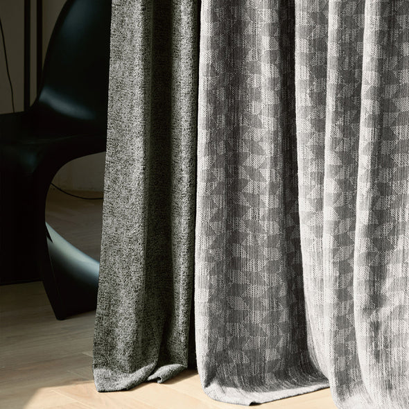 Close-up of NOVA curtain fabric, highlighting geometric pattern and thick blackout material, showcasing premium craftsmanship and tactile texture.